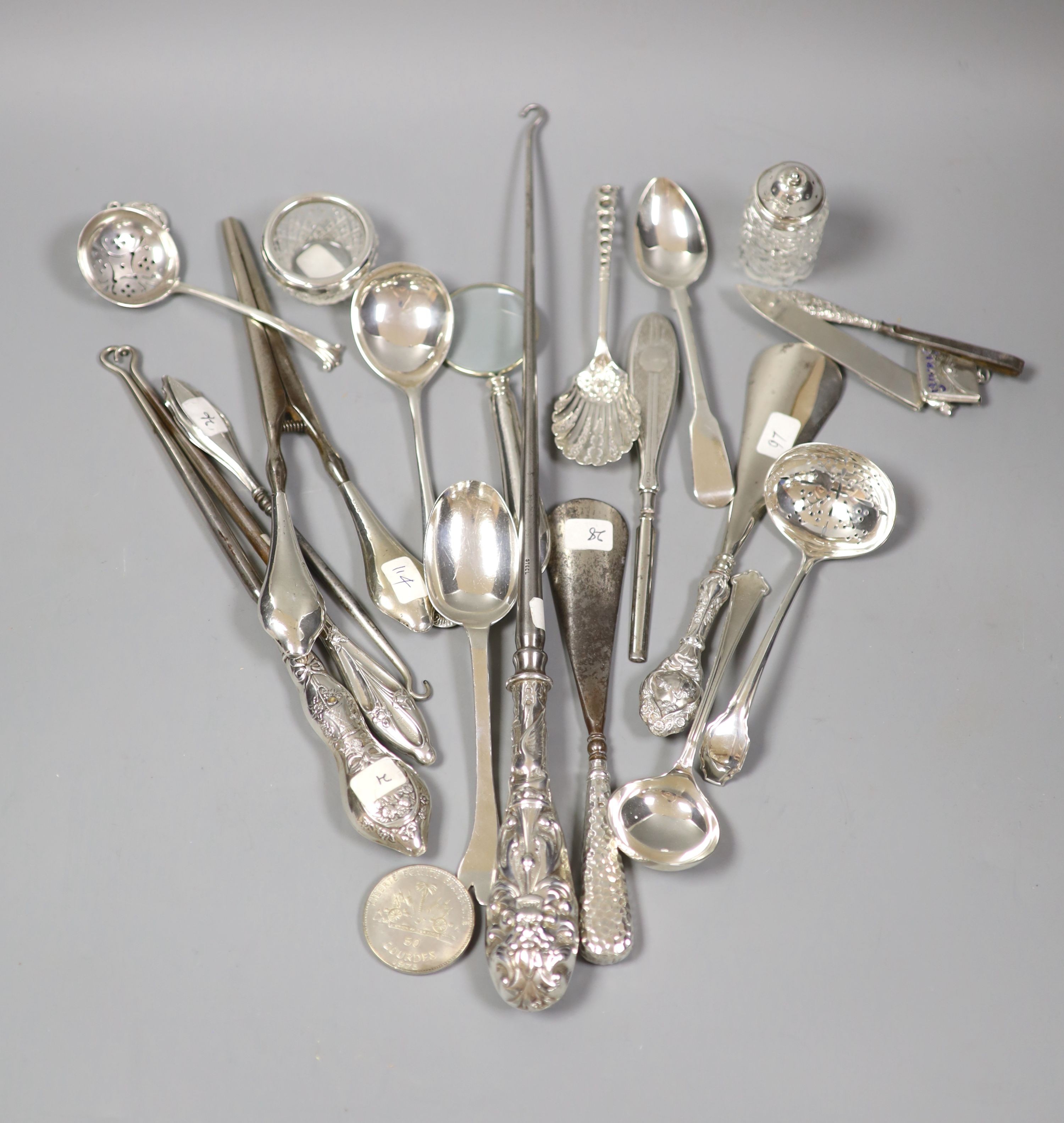 Assorted button hooks and other small silver including spoons, magnifying glass, glove stretchers, shooting related medallion and enamelled stamp case, etc.